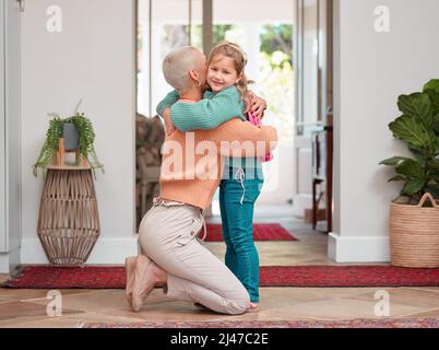I hope you have a good day. Shot of a woman seeing her daughter off before school. Stock Photo