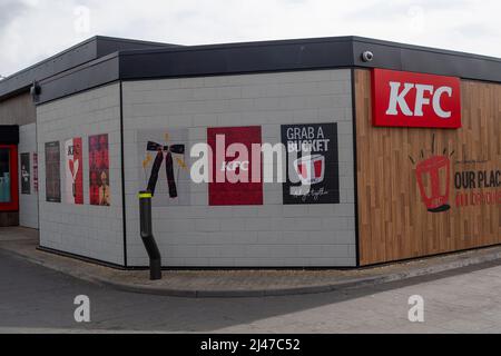 Slough, UK. 12th April, 2022. A KFC drive through in Slough. Footage filmed at Moy Park by undercover investigators working on behalf VFC a vegan food brand, has allegedly captured distressing footage of dead poultry in densely packed live chicken sheds. Moy Park are a supplier of chicken to fast food chain KFC. Animal Rights Campaigners have been very concerned for many years about the welfare of poultry farmed for the fast food industry and cheap supermarkets. Credit: Maureen McLean/Alamy Live News
