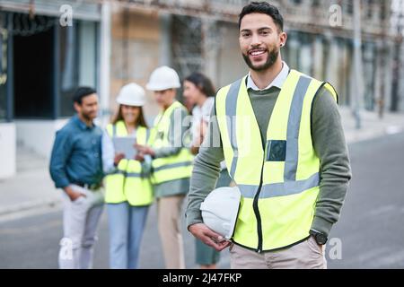 Either you run the day or the day runs you. Shot of a young woman working on a construction site. Stock Photo