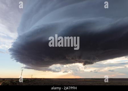 Dark storm clouds rolling over a field near Amherst, Texas Stock Photo