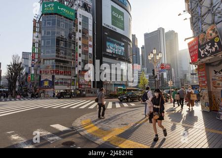 Shinjuku street view in front of Yunika Building on April 12, 2022 in Tokyo, Japan. Temperatures in Tokyo were over 25 Celcius for the third day running on Tuesday reaching summer levels in mid-April. Stock Photo