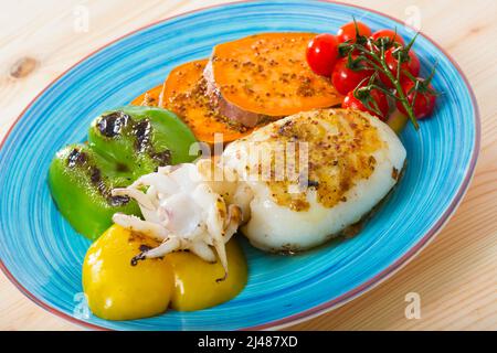 Image of sepia fried on a grill with pepper, boiled batat and honey-mustard sauce Stock Photo