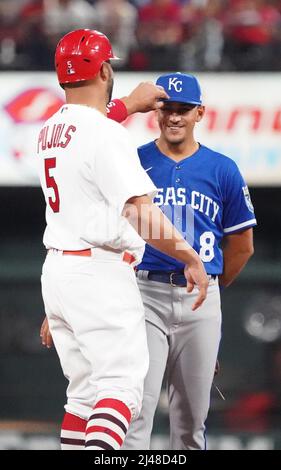 St. Louis, United States. 13th Apr, 2022. St. Louis Cardinals Albert Pujols plays with the cap of Kansas City Royals second baseman Nicky Lopez after hitting a single in the fifth inning at Busch Stadium in St. Louis on Tuesday, April 12, 2022. Photo by Bill Greenblatt/UPI Credit: UPI/Alamy Live News Stock Photo
