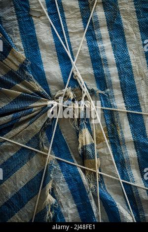 A package wrapped in a tarpaulin and tied with rope, Stanley, Hong Kong Island, 2007 Stock Photo
