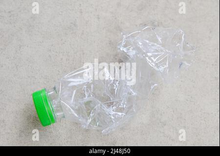 Crushed plastic bottle on floor Stock Photo