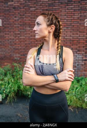 Sporty woman with crossed arms posing Stock Photo