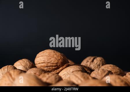 Walnuts on a dark background. Nutcracker close-up. Stock Photo