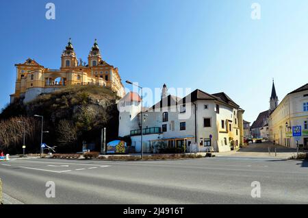 Melk, Austria - March 26, 2022: Townscape with impressive baroque Melk Abbey, pedestrian zone and Parish Church of the Assumption of the Virgin Mary i Stock Photo