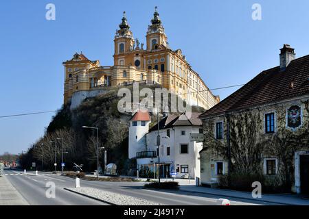 Melk, Austria - March 26, 2022: Impressive baroque Melk abbey on rock in UNESCO world heritage site of Danube Valley and building with former post off Stock Photo