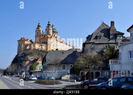 Melk, Austria - March 26, 2022: Impressive baroque Melk abbey on rock in UNESCO world heritage site of Danube Valley and buildings, Stock Photo
