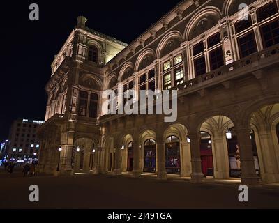 View of the illuminated facade of famous Vienna State Opera building (19th century, renaissance revival) by night in Austria. Stock Photo