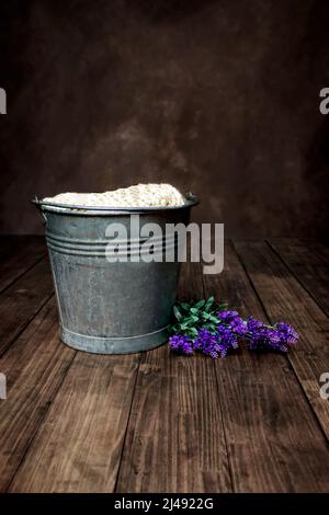 Newborn Baby Digital Background Rustic vintage bucket on a dark brown wood floor Stock Photo