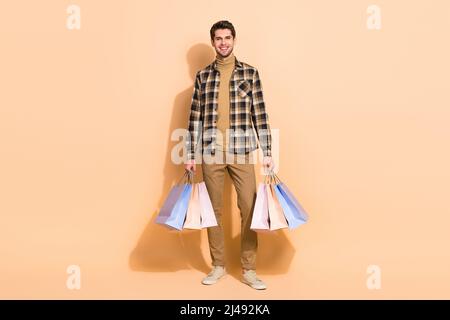Full body photo of positive guy hold many packages bought specials offers shops isolated pastel color background Stock Photo