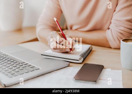 Man writes business information in notebook at workplace in office Stock Photo