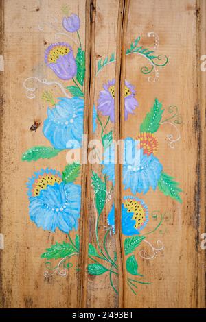 Blue flowers painted on wooden panel Stock Photo
