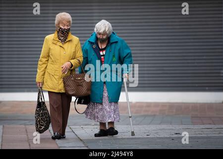 MERTHYR TYDFIL, WALES - NOVEMBER 07: Two women wear face masks as they walk through the town centre on November 07, 2020 in Merthyr Tydfil, Wales. The Stock Photo
