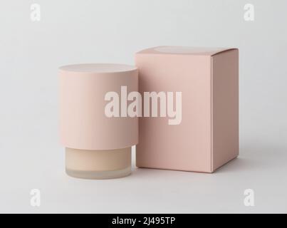 small pink cosmetic bottle without label with plain box isolated on white background Stock Photo