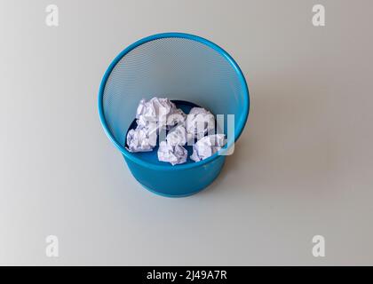 Crumpled paper balls in a basket Stock Photo