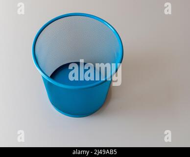 Blue mesh empty basket on a gray background Stock Photo