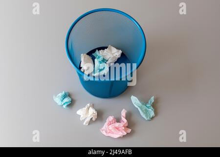 Throw away tissue paper in and out side of trash bin Stock Photo