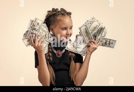 pretty teen girl with pigtails has lots of money isolated on white, dollar Stock Photo