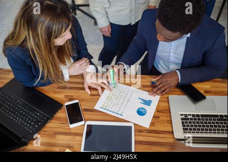 Diverse colleagues working on project in office Stock Photo