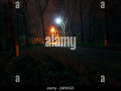 Walkway through a park at night . Illuminated park at nighttime Stock Photo