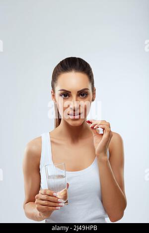 Portrait of beautiful woman holding glass of fresh water. Stock Photo