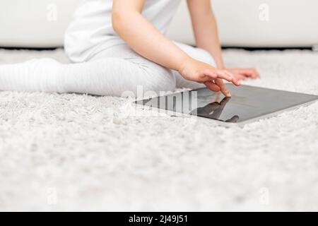 The child plays on the tablet. Stock Photo