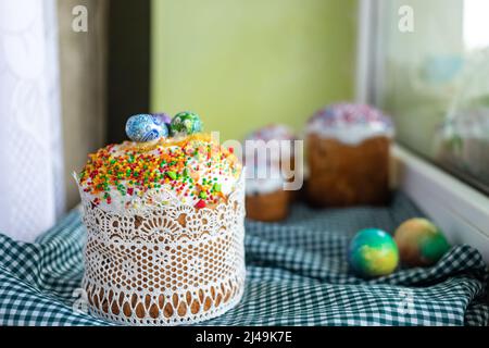 Traditional Easter cake with glace icing and Easter eggs on wooden background with willow twigs. Spring season. Orthodox Easter. Close up, selective f Stock Photo