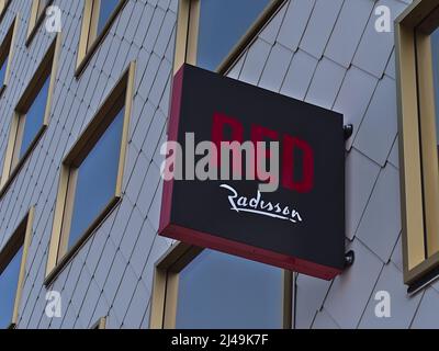 Close-up view of a sign with logo of hotel chain Radisson Red on the facade of a modern building in the downtown of Vienna, Austria. Stock Photo