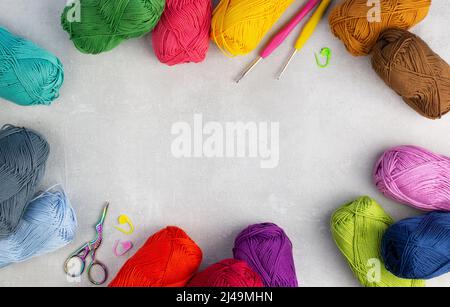 knitting pink crochet hooks and woolen thread on a blue background Stock  Photo - Alamy