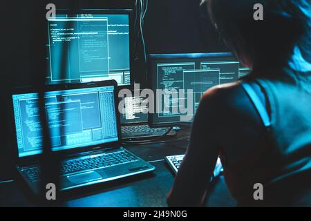 Software developer freelancer woman female work with program code on wide displays at night Develops new web desktop mobile application. Coder work on Stock Photo