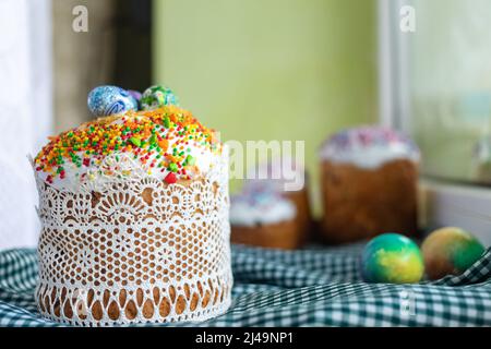 Traditional Easter cake with glace icing and painted easter eggs.Rustic style. Easter arrangement. Stock Photo