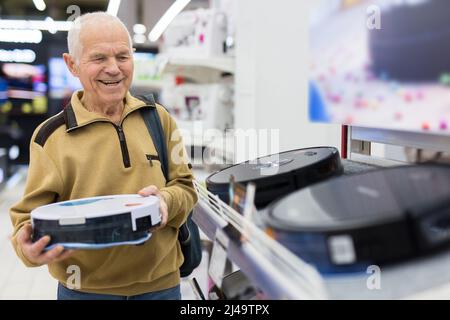 elderly grayhaired man pensioner examining counter with electronic