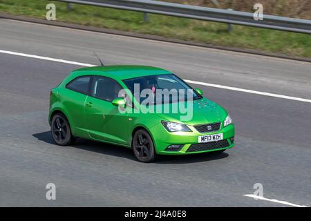 2013 green Seat Ibiza Toca 1390cc petrol 2dr small city car; driving on the M61 motorway, UK Stock Photo
