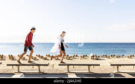 Happy couple having fun together enjoying a summer vacations at the beach. Stock Photo