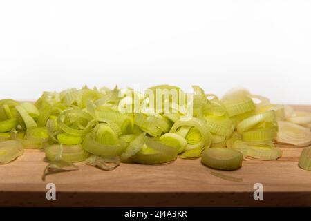 Rings of chopped leeks on a wooden board Stock Photo