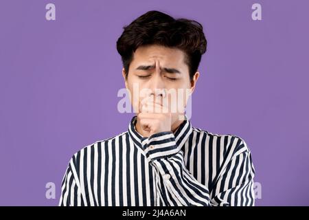 Exhausted Sleepy Young Asian Man Yawning At Studio Stock Photo