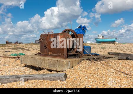 An old rusty winch on a shingle fishermans beach Stock Photo