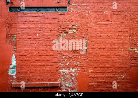 brick wall of a house painted red Stock Photo