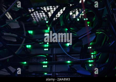 All systems go. Cropped shot of a large, dark and empty server room. Stock Photo