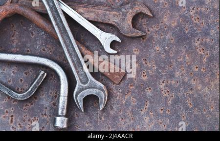 Collection of old garage hand tools on rusty metal table. Top view Stock Photo