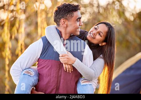 Happy campers. Shot of a young couple having a good time outside while camping outside. Stock Photo