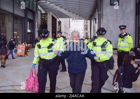 London, UK. 13th April 2022. Police officers arrest a protester. Extinction Rebellion activists caused chaos at the London headquarters of oil giant Shell, with dozens of protesters gluing themselves to the floor outside the entrance and several inside the building. Credit: Vuk Valcic/Alamy Live News Stock Photo