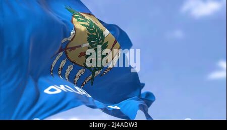 The US state flag of Oklahoma waving in the wind. Oklahoma is a state in the South Central region of the United States. Democracy and independence. Stock Photo