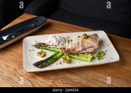 Restaurant Food - Rabbit Stew with Vegetables. Rabbit with artichoke cream and beurre blanc sauce. Copy space,Selective focus. Healthy concept Stock Photo