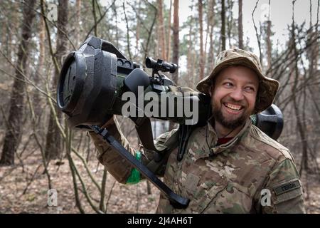 Ukraine. 12th Apr, 2022. Oleg (31) smiles as he holds the MBT-NLAW (Next generation Light Anti-tank Weapon) provided by the United Kingdom. As Russia retreated from Kyiv Oblast, and now concentrates the offensive in the eastern part of Ukraine, Alexander (48), Sergey (42), Andrew (41), Oleg (31) and their battalion might send to the Eastern part of Ukraine in a few days to join the battle operation. Credit: SOPA Images Limited/Alamy Live News Stock Photo