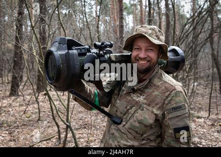 Ukraine. 12th Apr, 2022. Oleg (31) poses for a photo as he holds the MBT-NLAW (Next generation Light Anti-tank Weapon) provided by the United Kingdom. As Russia retreated from Kyiv Oblast, and now concentrates the offensive in the eastern part of Ukraine, Alexander (48), Sergey (42), Andrew (41), Oleg (31) and their battalion might send to the Eastern part of Ukraine in a few days to join the battle operation. Credit: SOPA Images Limited/Alamy Live News Stock Photo