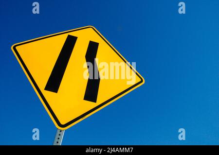 Freeway sign showing merge left as lane ends Stock Photo